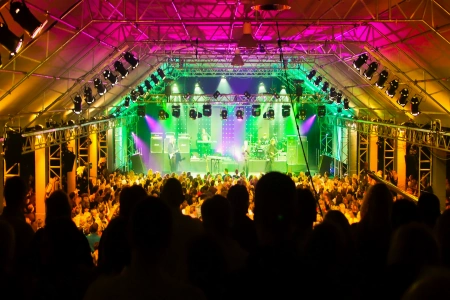 Dicht gedrängt steht das Publikum in der Tonhalle München. Auf der Bühne spielt eine Band und die Halle ist in buntes Licht getaucht.