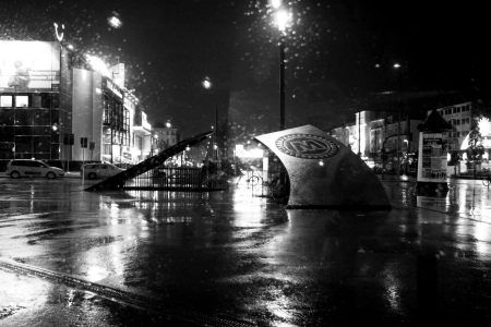 Ganz in Schwarz-Weiß gehalten die regennasse Reeperbahn. Auf dem Vorplatz zum Mojo Hamburg ist das Club Logo zu sehen